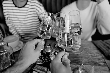 Friends with glasses of wine clink glasses holiday, a group of people abstract blurred background