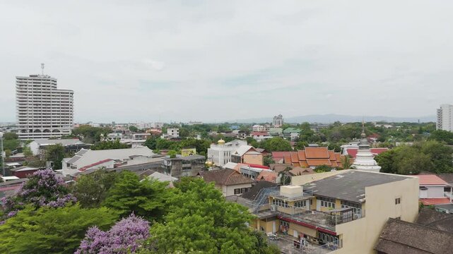 Chiang Mai Skyline In Thailand With View Of Wat Ket Karam Chedi And Roof. wide aerial shot