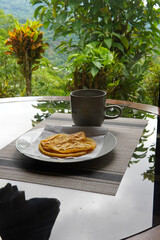 Typical Costa Rican breakfast: tortilla with egg and a glass of coffee or torta de huevo con tortilla