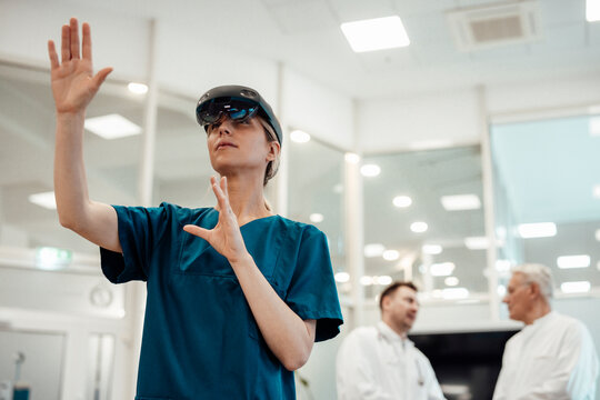 Doctor using virtual reality technology in a modern medical office with colleagues in the background