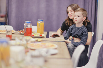 6 years old boy at a birthday party, celebration at a cafe dinner