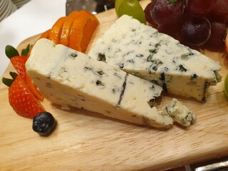cheese and olives on wooden board