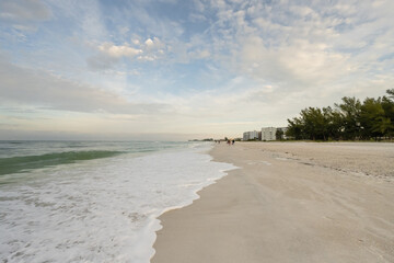 Gentle waves crash the scenic shoreline on Holmes Beach, Florida