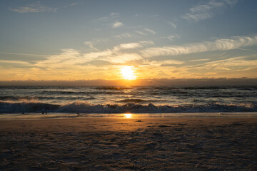 Sun sets while waves crash the shoreline of Holmes Beach
