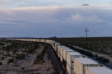 Container train curving off into distance at sunset