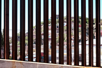 Close up view looking through U.S. Mexico border wall fence