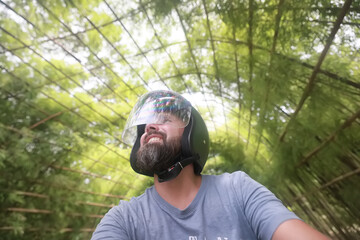 Bearded hipster guy in motorcycle helmet, happy portrait