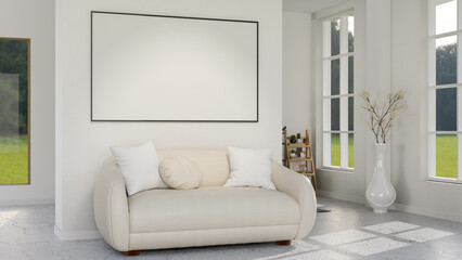 White sofa on carpet under a blank board or photo frame on living room wall with green lawn outside.