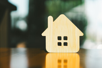 Wooden house model on wood background, a symbol for construction , ecology, loan, mortgage, property or home.