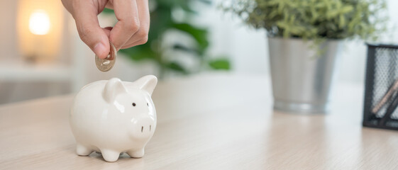Save money. business woman putting coin into piggy bank for saving. wealth, Finance, business,...