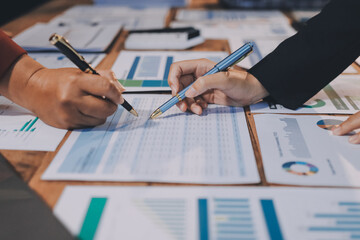 Group of business people brainstorming in analytical plan meeting Calculate the numbers obtained...