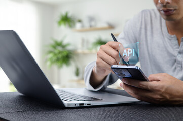 Programmer Working on API Development with Laptop and Smartphone