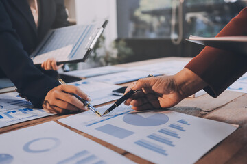 Group of business people brainstorming in analytical plan meeting Calculate the numbers obtained...