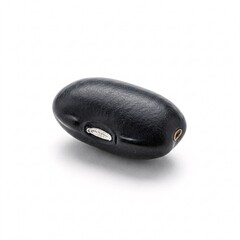 A black bean lying on a white background.