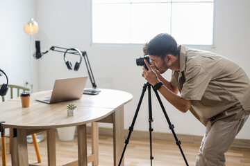 Man Getting Ready to Film Podcast, Setting Camera at Home Studio
