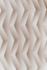 Abstract Chevron Pattern,3D Beige Geometric Texture,Close-up of an abstract, three-dimensional chevron pattern with a light beige tone. Geometric surface with a minimalist design, suitable