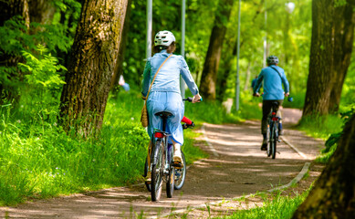 Cyclists ride on the bike path in the city Park
