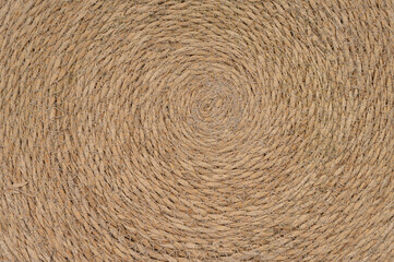 Retro fabric texture..Natural fiber rope arranged in a circular pattern. Detailed texture and earthy beige tones create a rustic and organic aesthetic, perfect for backgrounds, crafts