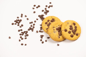 Cookies with chips and chocolate pieces arranged on a white background. A delicious dessert composition, ideal as a sweet snack