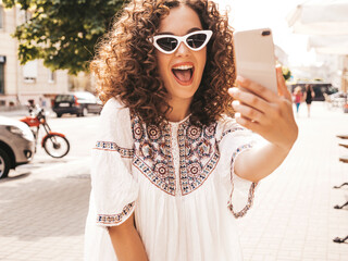 Beautiful smiling model with afro curls hairstyle dressed in summer hipster white dress.Sexy...