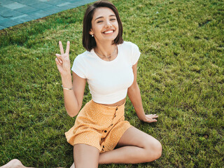 Portrait of beautiful smiling brunette model dressed in summer hipster  clothes. Trendy female...