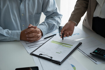 Businessman and businesswoman working together in an office