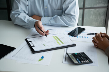 Businessman and businesswoman working together in an office