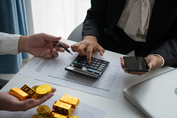 Businessmen discuss investing in gold bars and stocks