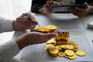 Businessmen discuss investing in gold bars and stocks
