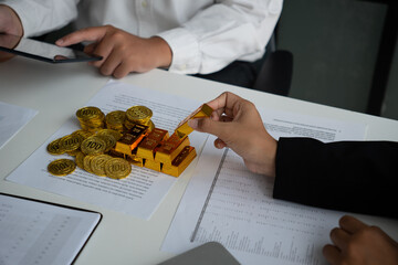 Businessmen discuss investing in gold bars and stocks