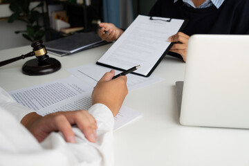 Lawyers meeting with legal counsel, holding lawyer's hammers