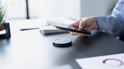 Woman using wireless charger charge smartphone