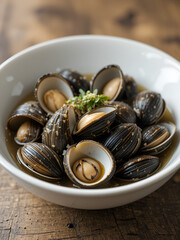 Fototapeta premium Bowl with live Italian vongole, sea truffles, and some grooved sword razor clams in seawater with their siphons visible.