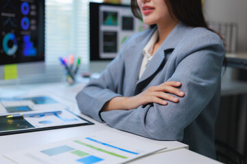 Businesswoman analyzing financial charts on computer in office, embracing data driven decision making