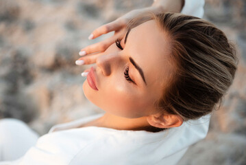 Charming fashion model having photo session in sand quarry