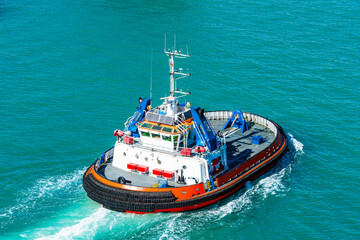Naklejka premium Modern tugboat in blue water, rear view