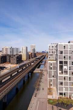 High contrast view of metro structure and modern buildings in &Oslash;restad, with elevated angles, urban design elements and daylight reflections creating an efficient composition.