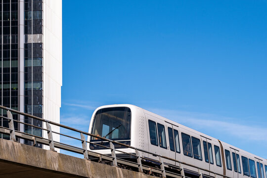 Copenhagen&rsquo;s elevated metro gliding above street level among minimalist buildings in &Oslash;restad, showing movement, innovation, and urban functionality in daylight.