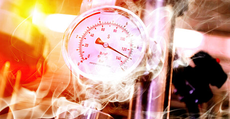Pressure gauge displaying high readings in a manufacturing facility with smoke and steam present