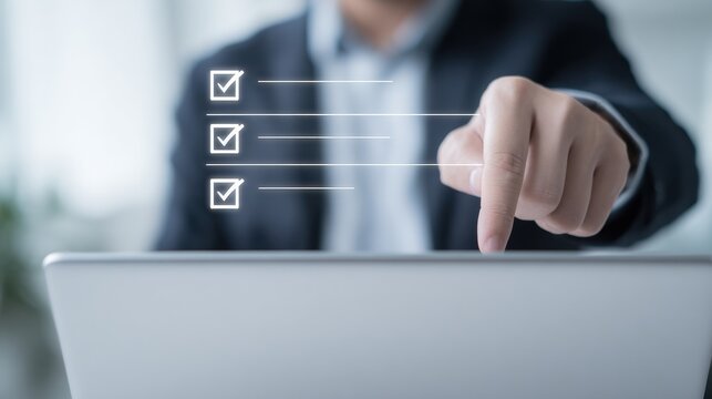 Professional Hand Checking Off Tasks on Laptop Screen with Digital Checkmarks in Modern Office Environment