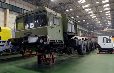 Military equipment manufacturing at Wheel Tractor Plant showing a wheel tractor assembly in progress