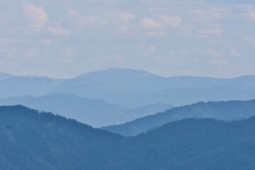 foggy peaks of blue mountains in the distance, blue mountains of the Altai Republic in the distance