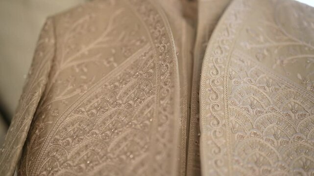 The groom shines in a richly embroidered sherwani, captured in a stunning close-up. His confident smile, elegant turban, and royal aura reflect tradition, style, and the joy of his wedding day.