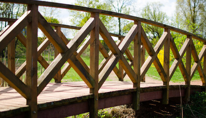 Timber bridge with natural finish in landscaped area