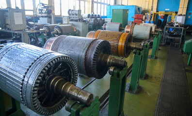 Industrial workshop showcasing multiple electric motors undergoing maintenance and inspection during daytime operations