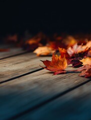 Obraz premium Autumn leaves scattered on a wooden deck, creating a warm, tranquil atmosphere in nature
