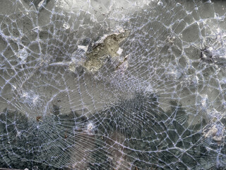 Cracked TV screen close-up. Shattered smashed glass of LED monitor.