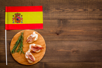 Welcome to Spain. Parma ham and Spanish flag, top view