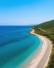 Fototapeta premium Serene Coastal View with Curving Road Next to Clear Turquoise Water and Lush Green Hills under Bright Blue Sky