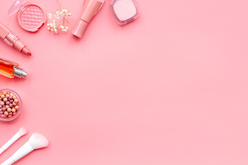 Makeup accessories - brushes and pink pastel cosmetic products, flat lay, top view